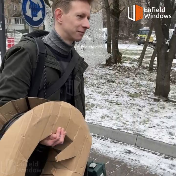 Майстер несе в руках 450-метрову бухту ущільнювача на об'єкт до клієнта Бухта EPDM ущільнювача для пластикових вікон